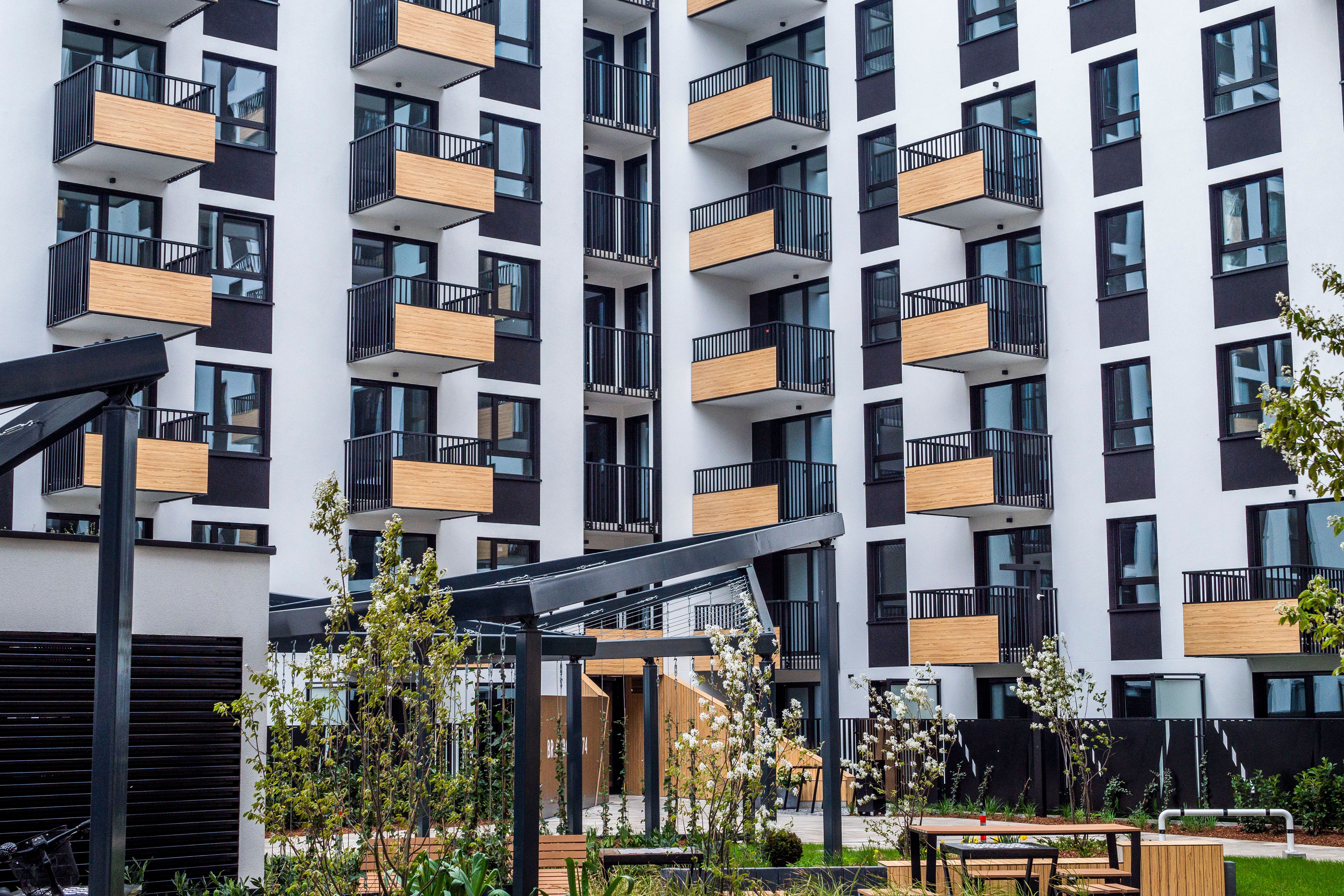 Modern apartment complex representing sectional title property investment and rental stock