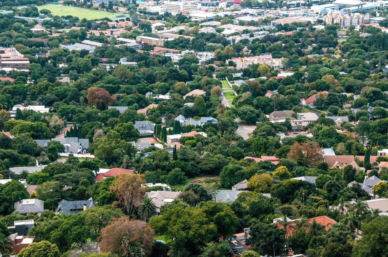 Aerial view of a leafy Gauteng residential neighbourhood representing local property investment markets